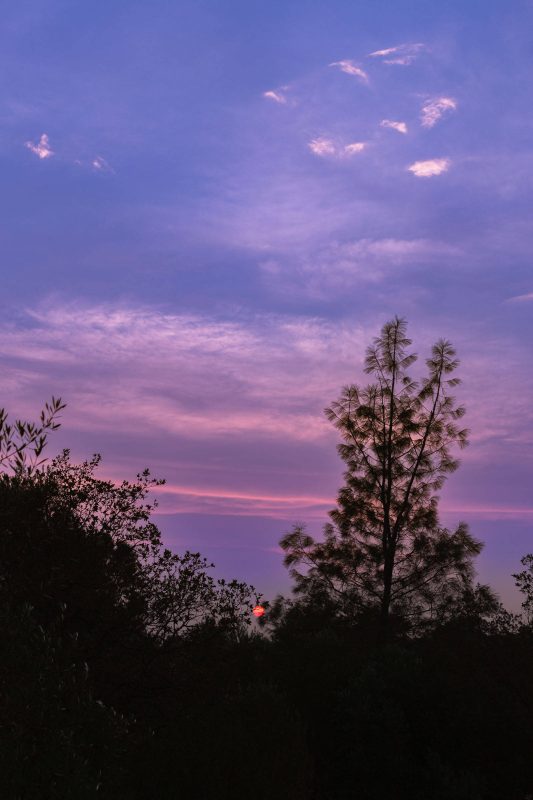 Sun pokes through clouds at sunset.